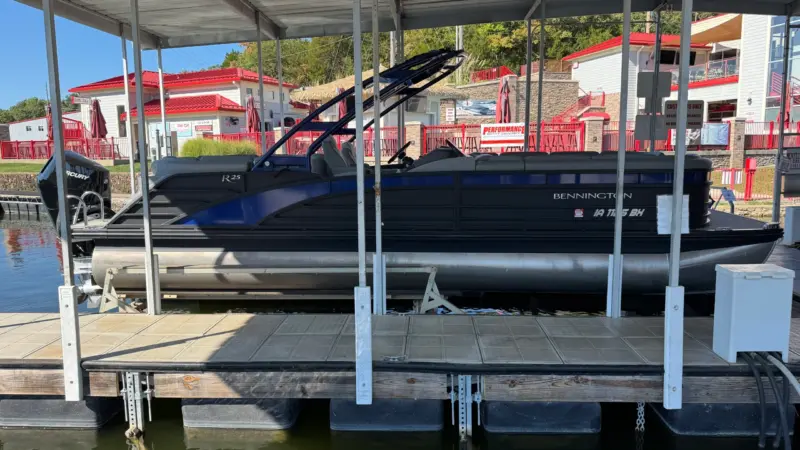 Profile view of a 2023 Bennington 25 RFBA pontoon boat docked