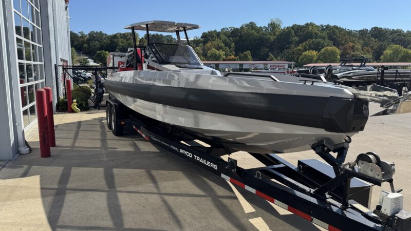 Front three-quarter view showing the starboard hull of a grey 2026 IRON 907 boat